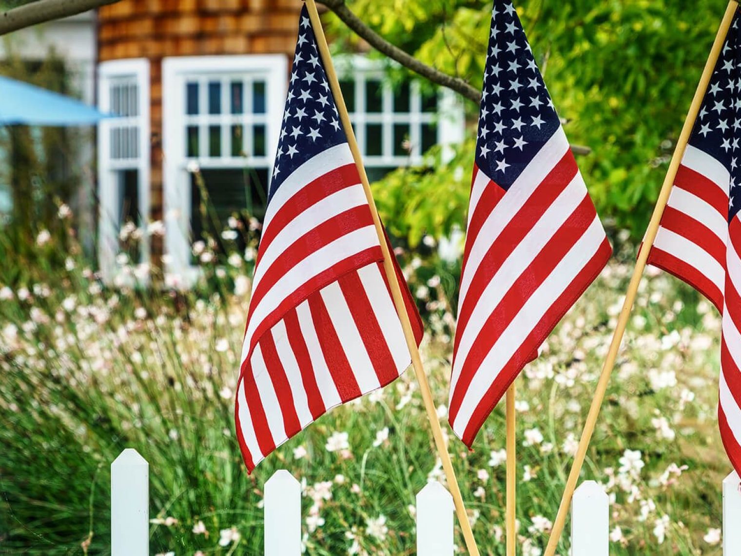 American flags hanging outside of home.