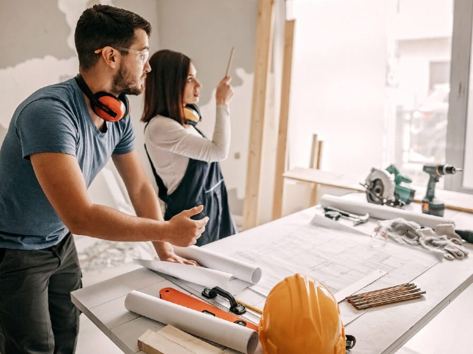 Couple having discussion while doing large scale home renovations.