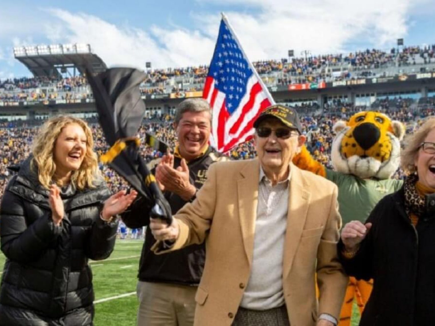 Football fans cheer for major Harvey B. Young Jr.