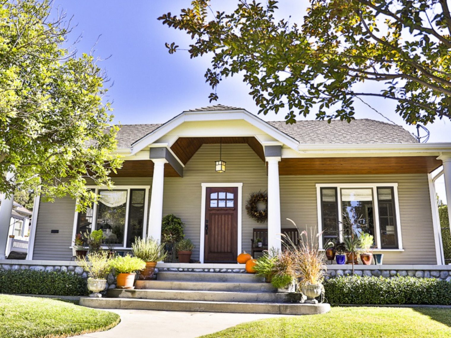 Home with potted plants on the front porch.