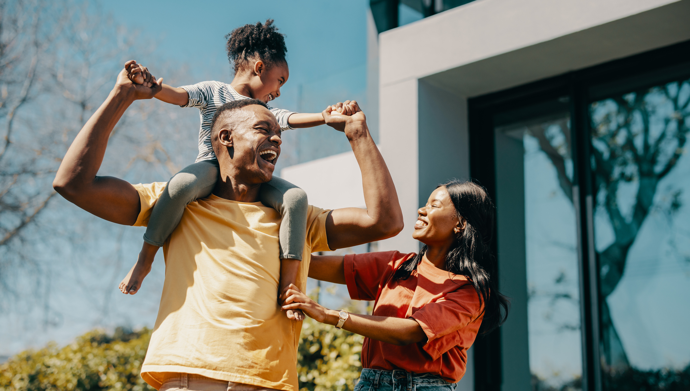 African American family outside their new home.