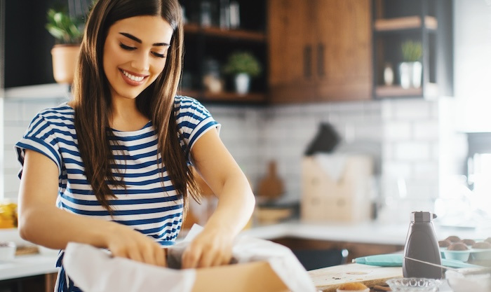 Woman arranging items in a box.