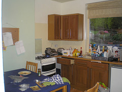 Extremely messy kitchen filled with junk.